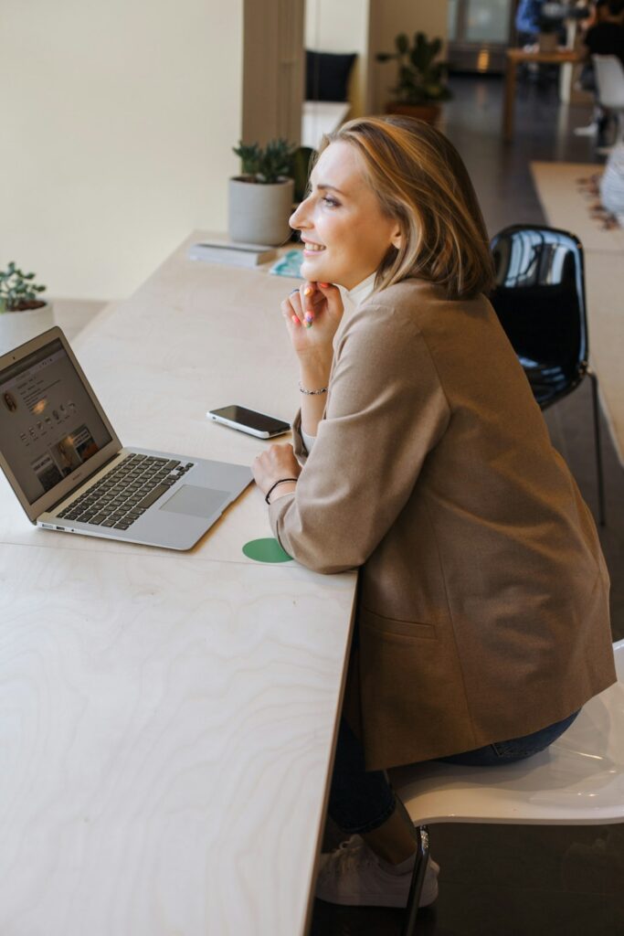 woman-in-brown-coat-using-macbook-air-dj5hnhmtkh0